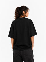 Person wearing a black t-shirt on a white background