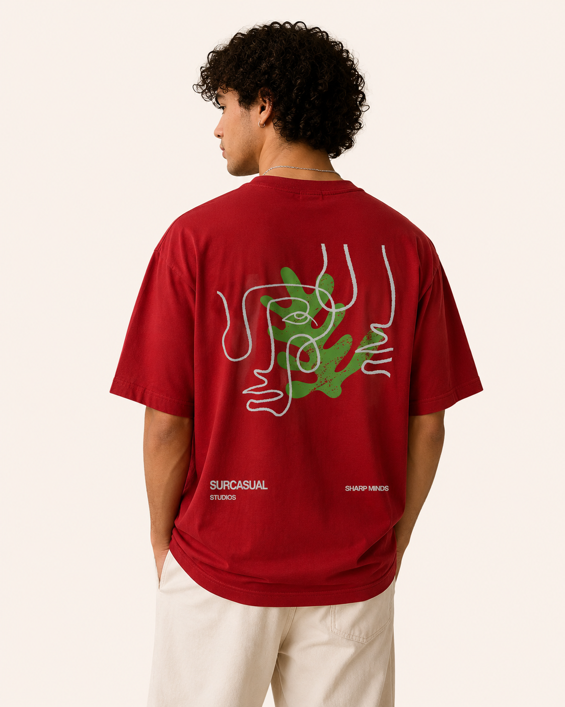 Person wearing a red t-shirt with a graphic design on the back, standing against a plain background.
