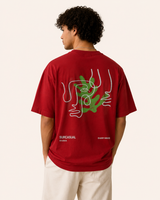Person wearing a red t-shirt with a graphic design on the back, standing against a plain background.