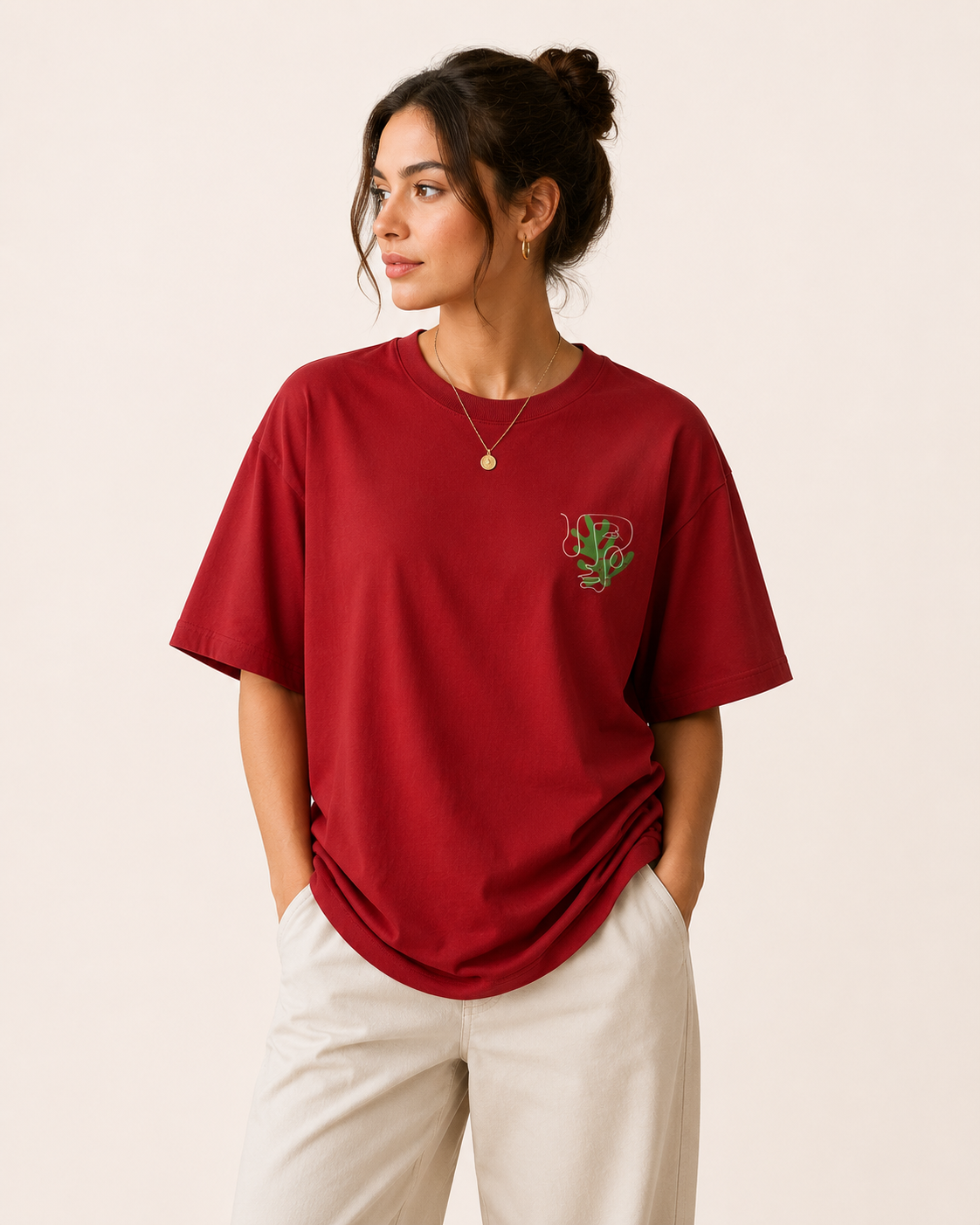 Woman wearing a red t-shirt with a green logo on a beige background